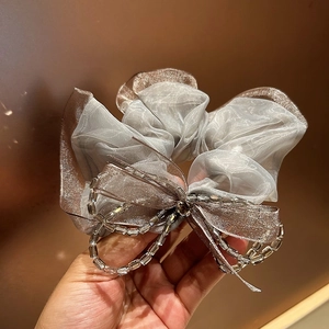 Detail of silver grey organza scrunchie with lace bow and crystal beaded chain