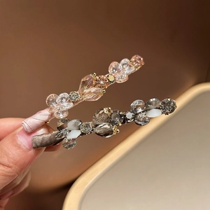 Detailed view of handmade crystal hair clips with beads in champagne pink and smoke grey