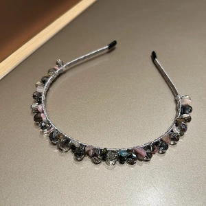 Detailed close-up of handmade beaded headband with sparkling crystals and silver wire wrap