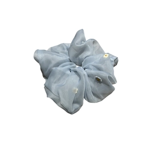 Light blue organza scrunchie with daisy embroidery for a fresh and elegant hair style