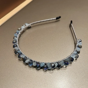 Detail of handcrafted blue crystal beaded headband with intricate wire-wrapped gemstones