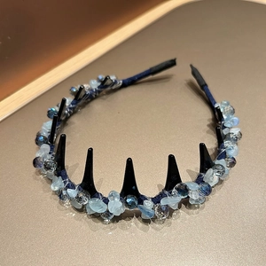 Detail of navy blue headband with light blue crystal beads and black teeth for hair grip
