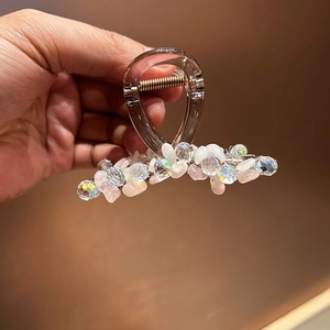Vue détaillée de la pince à cheveux artisanale avec perles colorées, cristaux et résine ambrée