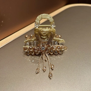 Detailed luxury champagne gold hair claw with hanging crystal tassels and diamond flower
