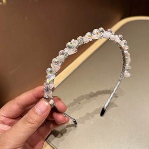 Detail of handmade headband featuring pink natural stones and shimmering crystal beads