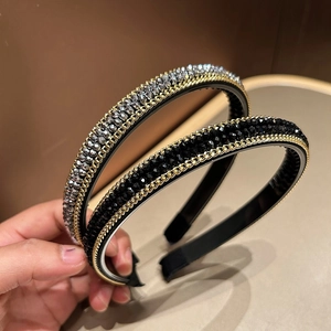 Detail of handmade beaded headbands with grey and black crystals and golden chains