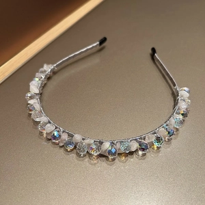 Detailed view of handmade crystal beads and white quartz stones on a silver wire headband