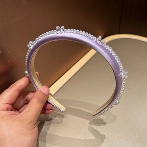 Close-up of luxury purple velvet headband featuring sparkling crystal bead embellishments