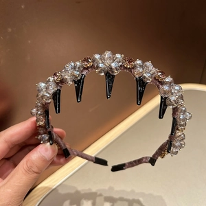 Detail view of crystal headband with light brown rhinestones and non-slip hair teeth