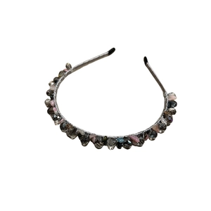 Elegant beaded headband with multicolored crystals and stones on a silver metal frame