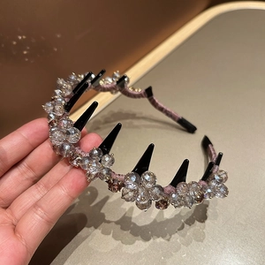 Detail view of pink silk crystal headband with black anti-slip hair comb teeth
