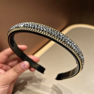 Close-up of handmade crystal beaded headband with luxury gold chain trim detail