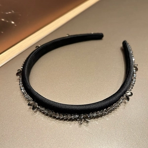 Detailed close-up of French vintage headband with gray crystals and black satin fabric