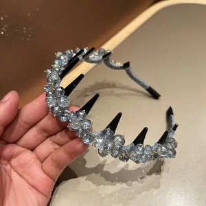 Detailed shot of silver-grey crystals on a black toothed headband with plastic grips