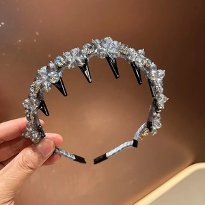 Detail of grey crystal headband with floral rhinestone clusters and non-slip hair teeth