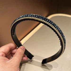 Detail showing non-slip teeth and crystal bead chains on a luxury black headband