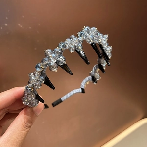 Detail showing grey-blue crystal beaded petals and black plastic hair clips on headband