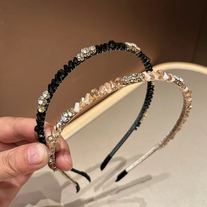 Detail of luxury thin headbands with black beads and champagne crystals on metal frames