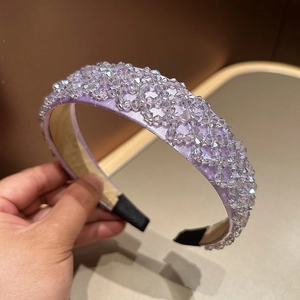 Close-up of lavender crystal beaded headband with intricate woven satin texture