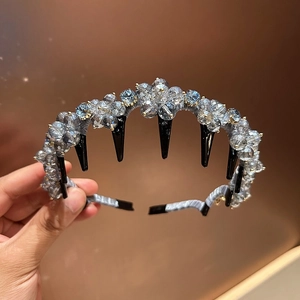 Detail of crystal flower headband with functional black hair-combing teeth