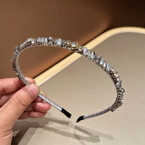 Elegant silver silk headband adorned with sparkling crystals and mother-of-pearl accents