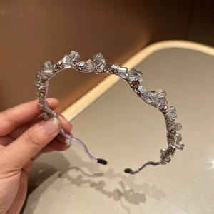 Detail of purple handmade beaded headband with sparkling crystals and faceted gemstones