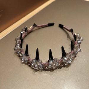 Detail of lavender satin headband with crystal beads and black styling comb teeth