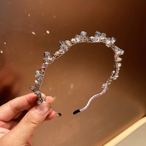 Close-up of handmade beaded headband featuring pink fabric with clear crystals and gold beads