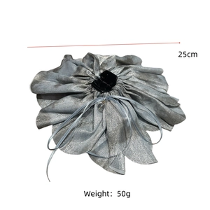 Detail of the oversized silver fabric flower hair claw with crystal pendant and sequins