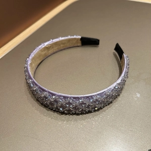 Detailed close-up of sparkling lavender crystal beads on a handmade woven wide headband