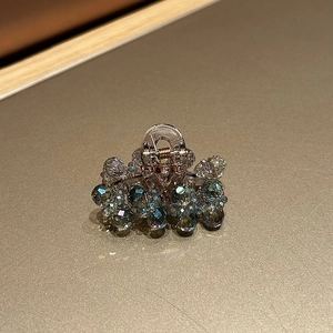 Macro detail of luxury crystal hair claw clip with blue and clear faceted beads