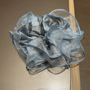 Detail of blue lace organza scrunchie with layered fabric and decorative beads