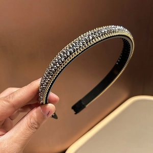 Detail of beaded headband with grey crystal beads and gold chain trim for women