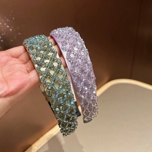 Close-up of handmade crystal beaded wide headbands in lavender and golden green