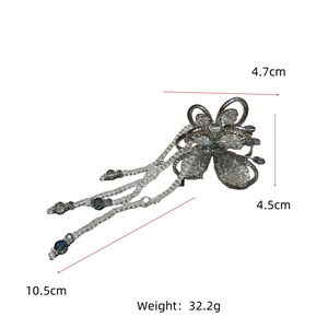 Detailed view of handmade butterfly hair claw size 4.7x4.5cm with blue crystal tassels