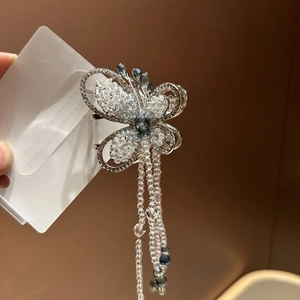 Elegant beaded crystal butterfly hair clip with blue and white long tassels and silver finish
