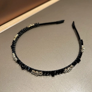 Detailed view of luxury thin black headband featuring clear and black rhinestones