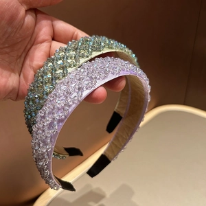 Detailed view of hand-woven beaded headbands in lavender and teal with sparkling crystals