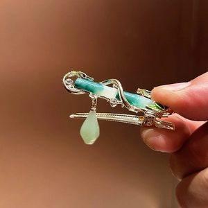 Hanfu style bamboo hair clip with green enamel, gold finish and pearl tassel details