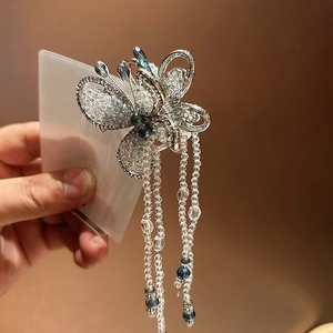 Elegant butterfly claw clip with blue crystal tassels and sparkling rhinestone accents