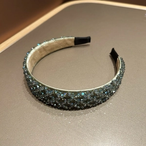 Detail view of handmade crystal beaded wide headband with blue faceted gems and soft lining