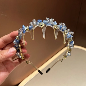 Detailed close-up of sky blue crystal stones and transparent beads on head comb