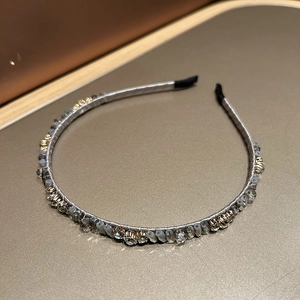 Detail of thin headband with grey beads and sparkling rhinestones on silk-wrapped band