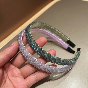 Detailed shot of handmade crystal beaded headbands in lilac and sage green