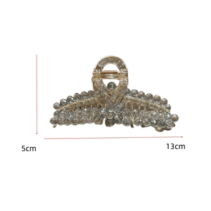Detail showing the 13cm size scale of a large crystal rhinestone hair claw clip