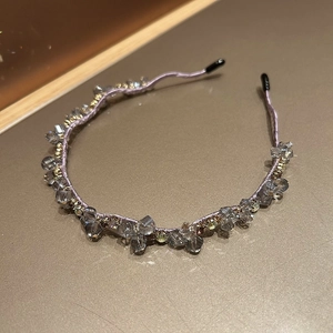 Detailed shot of purple crystal beaded headband with shimmering multi-cut gemstones