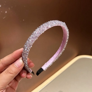 Detail of pink crystal beaded headband with satin lining and hand-woven rhinestones