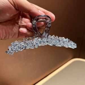 Close-up of lavender crystal beaded hair claw clip held in hand with sparkling details