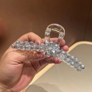 Detail of crystal flower hair claw clip with transparent beads and strong metal spring