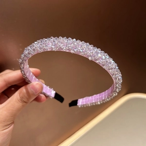 Macro shot of handcrafted light purple crystal beads on a wide braided headband